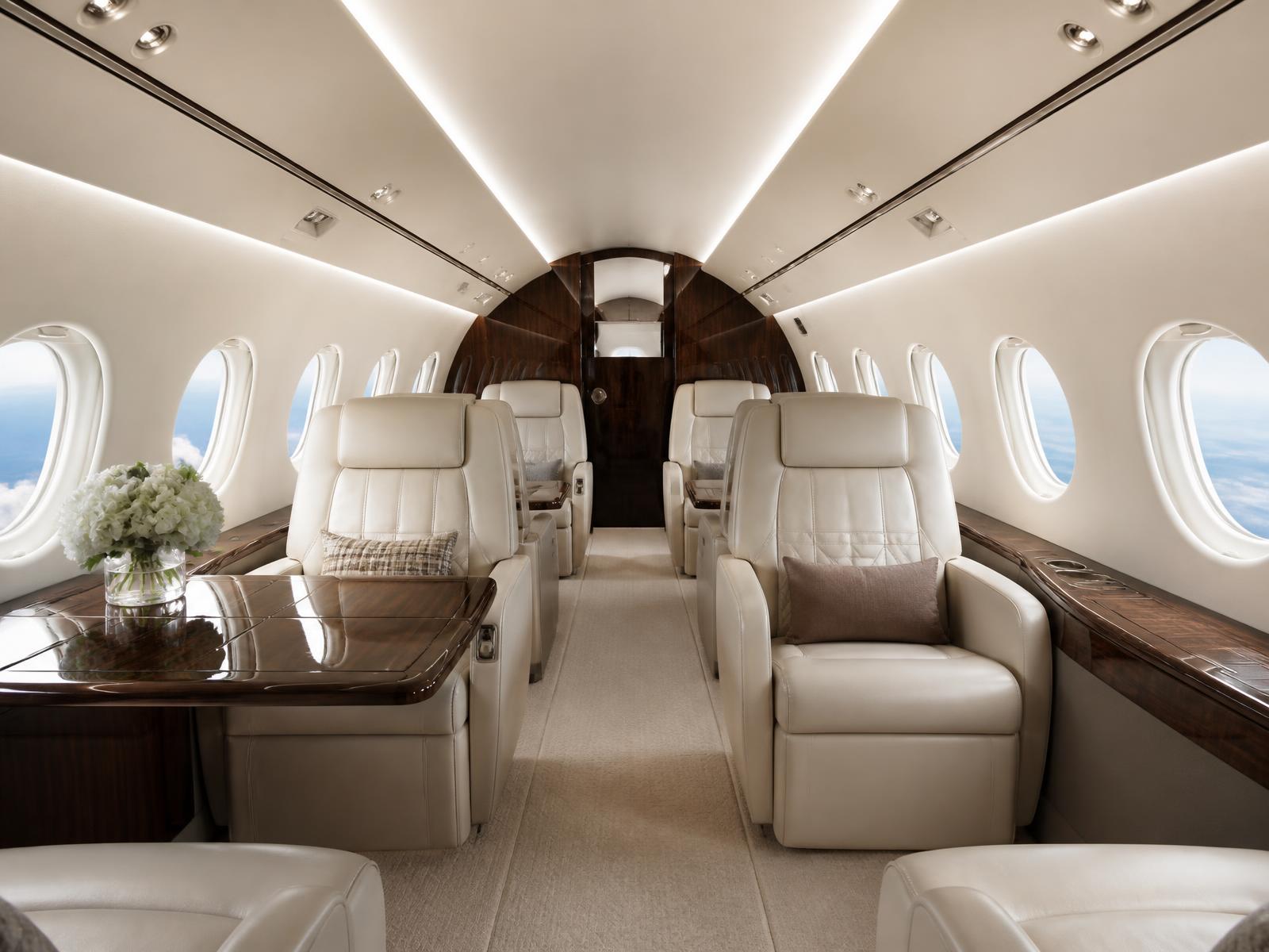 Interior cabin of a business jet with cream leather seating